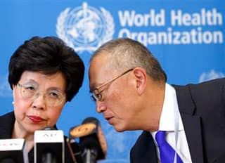 Director General of the World Health Organization, WHO, China's Margaret Chan and Assistant Director General for Health Security Keiji Fukuda of the US, right, share a word during a press conference after an emergency meeting at the headquarters of the WHO in Geneva, Switzerland, Friday, Aug. 8, 2014. (AP Photo/Keystone, Salvatore Di Nolfi)